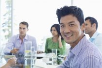 Businessman smiling in meeting at modern office — Stock Photo
