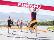 Runner crossing race finish line — Stock Photo