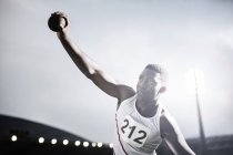 Track and field athlete throwing shot put — Stock Photo
