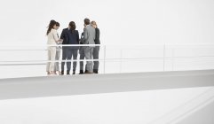 Business people meeting on elevated walkway — Stock Photo