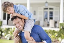 Father and son playing outside house — Stock Photo