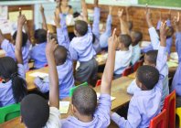 Африканские американские студенты поднимают руки в классе — стоковое фото