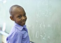 African american student at chalkboard in class — Stock Photo