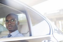 Business man sitting in car back seat — Stock Photo