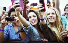 Fans with cameras and camera phones at music festival — Stock Photo