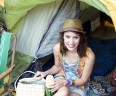 Portrait of smiling woman in tent at music festival — Stock Photo