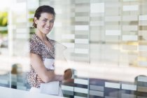 Businesswoman smiling in office at modern office — Stock Photo
