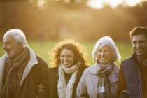 Happy caucasian family walking together in park — Stock Photo