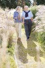 Older couple walking outdoors — Stock Photo