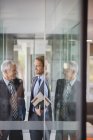 Businessmen talking in modern office building — Stock Photo