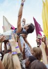 Performer crowd surfing at music festival — Stock Photo