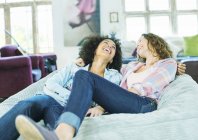 Women relaxing in beanbag chair together — Stock Photo