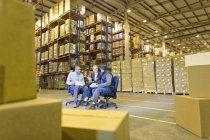 Business people talking in warehouse — Stock Photo