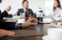 Close up of businessman hand in meeting at modern office — Stock Photo