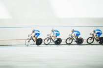 Cyclists racing around velodrome — Stock Photo