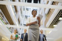 Business people walking in office building — Stock Photo