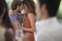Young attractive Couple hugging at party — Stock Photo