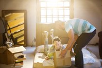 Young couple unpacking boxes in attic — Stock Photo