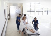 Hospital staff rushing patient to hospital room — Stock Photo