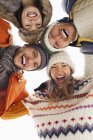 Low angle portrait of happy friends in huddle — Stock Photo