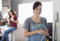 Skillful caucasian female electrician working on telephone in home — Stock Photo