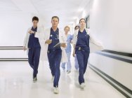Doctors rushing down hospital corridor — Stock Photo