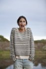 Portrait of surprised woman at lakeside — Stock Photo
