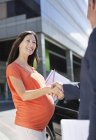 Pregnant businesswoman shaking colleague?s hand — Stock Photo