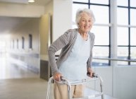 Senior patient using walker in hospital — Stock Photo