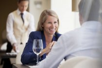 Business people smiling in restaurant — Stock Photo