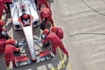 Racing team working at pit stop — Stock Photo