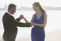 Happy well-dressed couple dancing at waterfront in Venice — Stock Photo