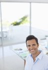 Caucasian businessman smiling at modern office — Stock Photo