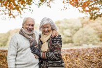 Older caucasian couple walking in park — Stock Photo