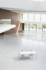 Table and chairs in empty office lobby — Stock Photo
