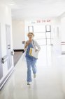 Doctor rushing down hospital corridor — Stock Photo