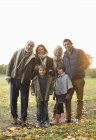 Family smiling together in park — Stock Photo