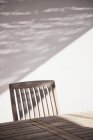 Mesa y silla de madera a la luz del sol - foto de stock