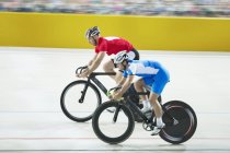 Track cyclists racing in velodrome — Stock Photo