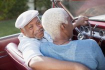 Older couple sitting in convertible — Stock Photo
