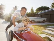 Father pushing son in go cart — Stock Photo