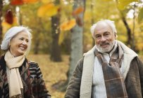 Older caucasian couple walking together in park — Stock Photo