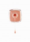Close up of peach fingernail polish dripping from bottle — Stock Photo