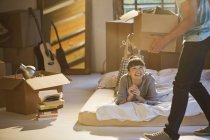 Young couple unpacking boxes in attic — Stock Photo