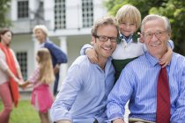Three generations of men smiling together — Stock Photo