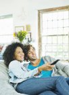 Couple watching television in beanbag chair — Stock Photo