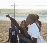African boys shouting together in dirt field — Stock Photo