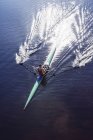 Man rowing scull on lake — Stock Photo