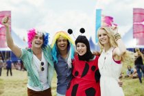 Portrait of friends in costumes at music festival — Stock Photo
