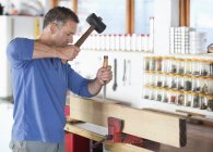 Skillful caucasian man working in workshop — Stock Photo